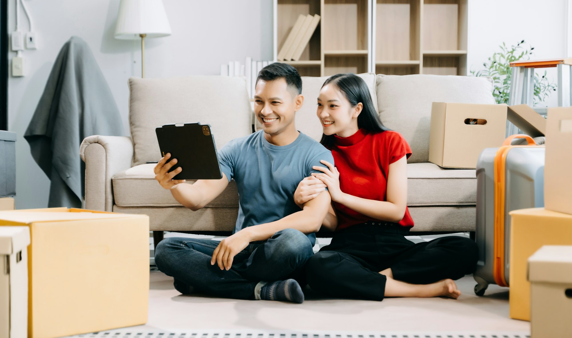 Asian young attractive couple man and woman use tablet and smartphone